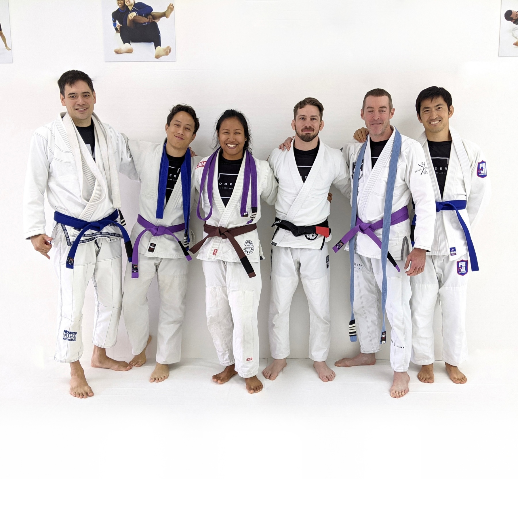 Photo of two students graduating to the rank of blue belt, two students graduating to the rank of purple belt, and Coach Sovannahry graduating to the rank of brown belt in Brazilian Jiu-Jitsu at Modern Martial Arts and Fitness in Pasadena, CA