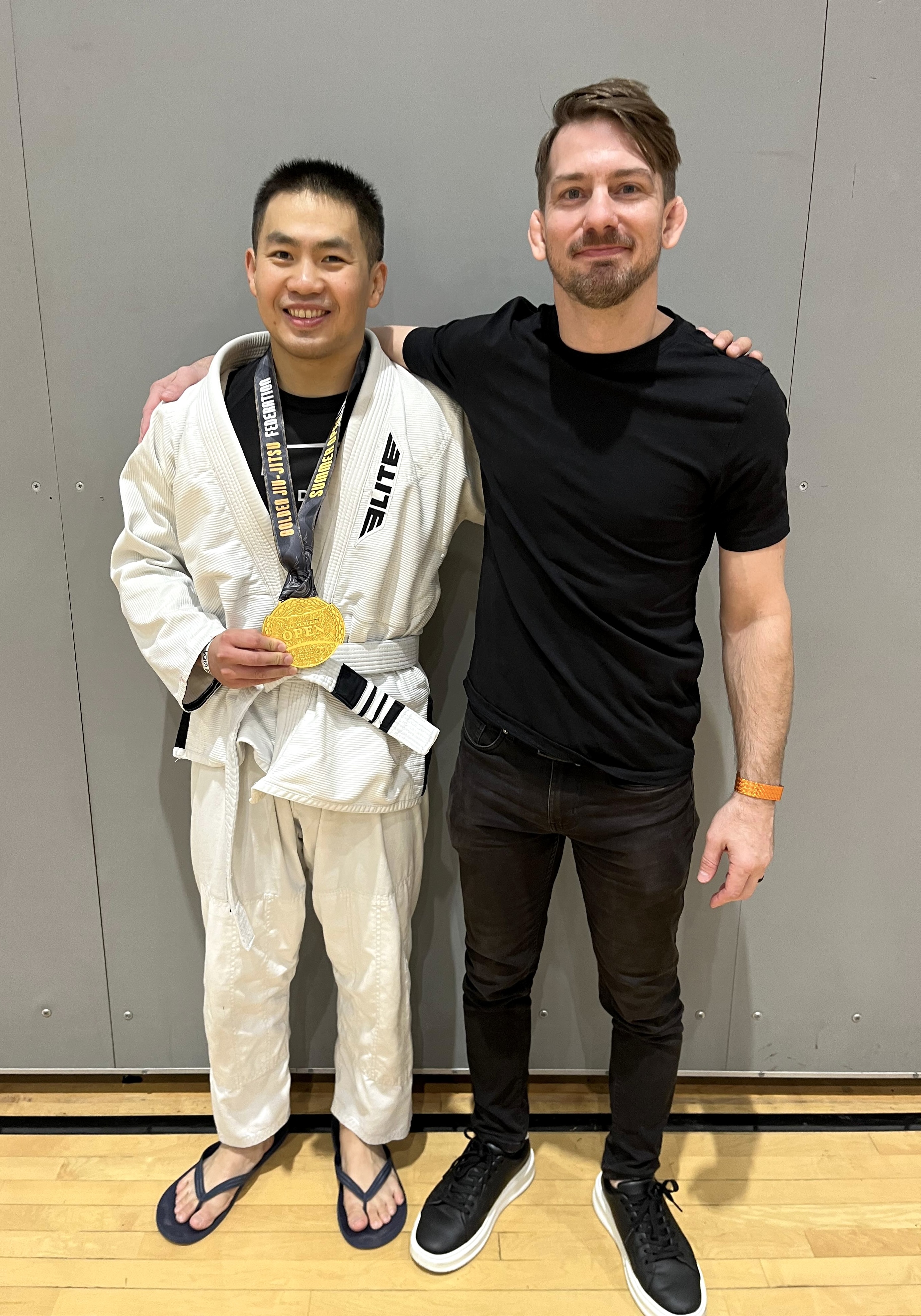 Scott Li celebrating with his coach after his BJJ debut victory